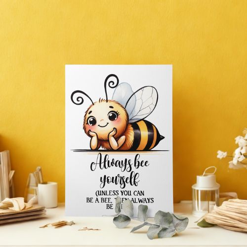 Cartoon bee with a motivational quote on a white background against a yellow wall.