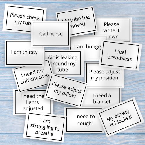 Set of Communication Cards for Tracheostomy Patients / medical alert cards with various messages on a wooden surface