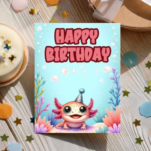 Birthday card with a cartoon axolotl and 'Happy Birthday' text on a wooden surface with a cake.