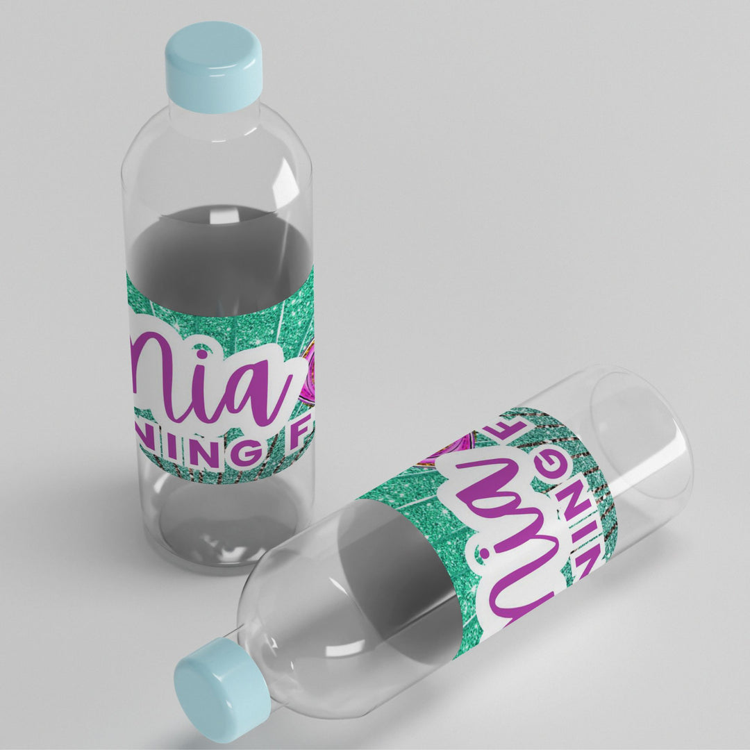Clear water bottles with colorful labels on a light gray background