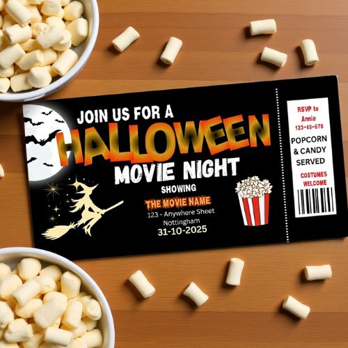 Halloween movie night invitation with popcorn and candy on a wooden table