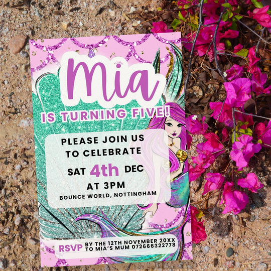 Children's birthday party invitation with colorful design and text, placed on a natural surface with pink flowers. part of the Editable Mermaid Birthday Bundle Canva Templates 