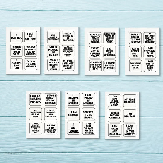 A selection of Motivational cards for kids and adults on a blue wood background