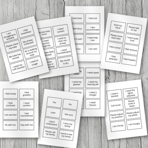 Set of Communication Cards for Tracheostomy Patients with text on a wooden surface