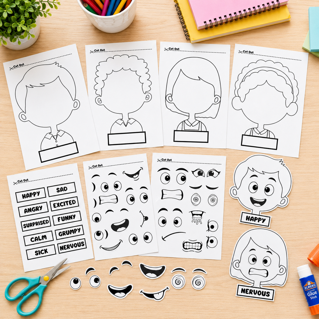 A set of printable face and expression activity sheets laid out on a wooden desk, with cut-out facial features, emotion words, and cartoon character head templates. Scissors, a plant, pens, and notebooks are visible around the sheets.