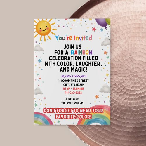 Invitation card with rainbow and sun design on a textured surface