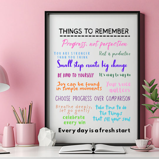 Framed motivational poster with colorful text on a pink wall with decor items.