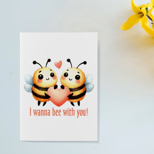 Printable Valentine’s Day & Anniversary Card with two cartoon bees holding a heart and text 'I wanna bee with you!' on a light blue background.