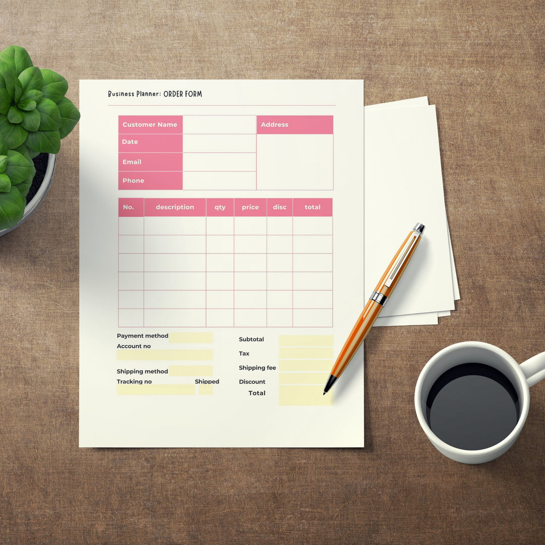 a Printable Business Planner for Etsy Sellers n a desk with a mug of tea and a pen
