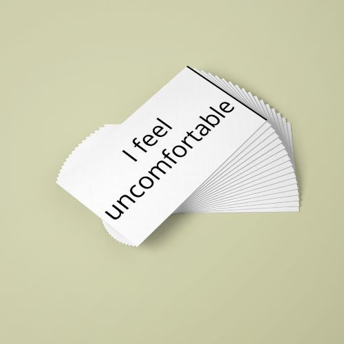 Stack of cards with 'I feel uncomfortable' text on a beige background